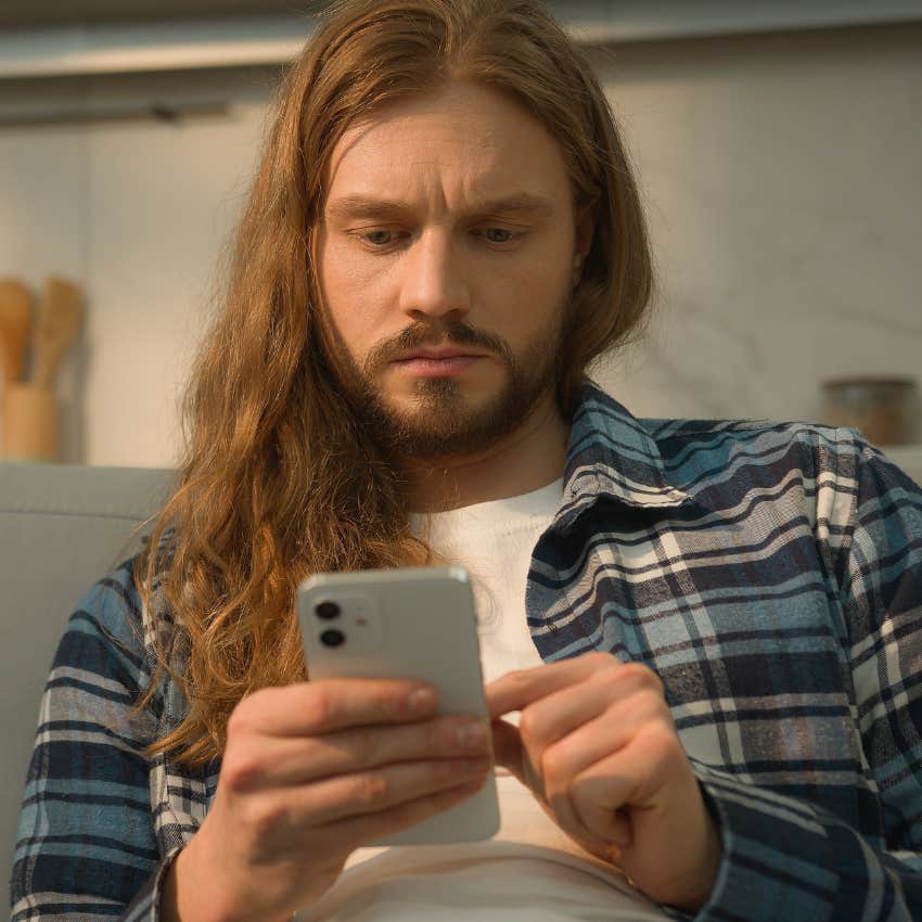 Man thinking about privacy while scrolling on his phone.