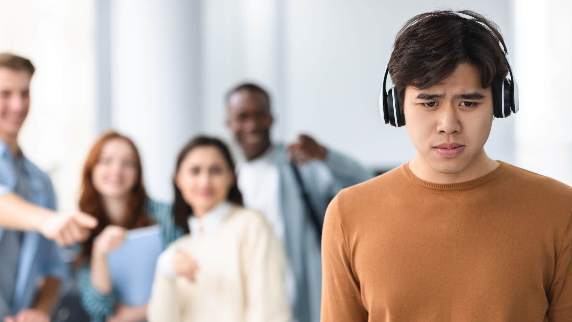 group ostracizing young man
