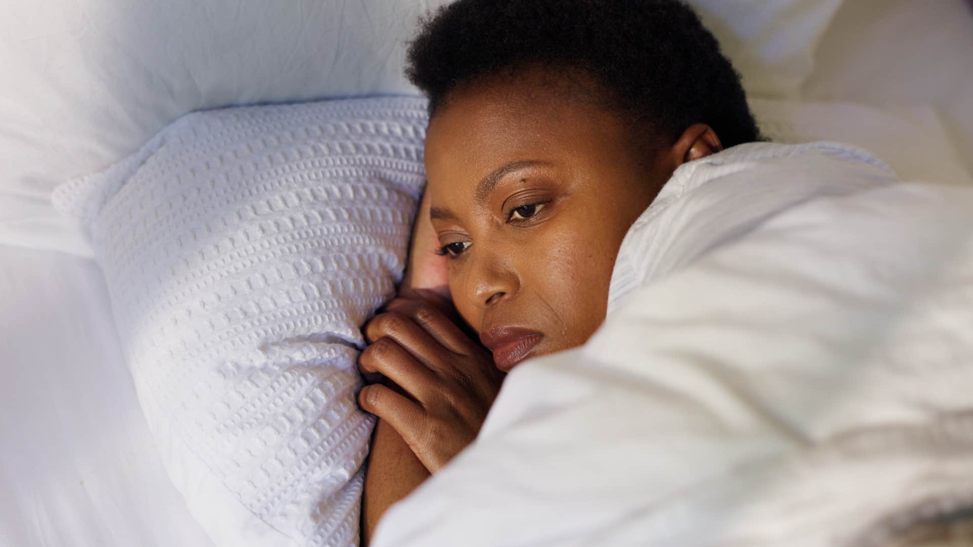 unhappy woman in bed expecting the worst