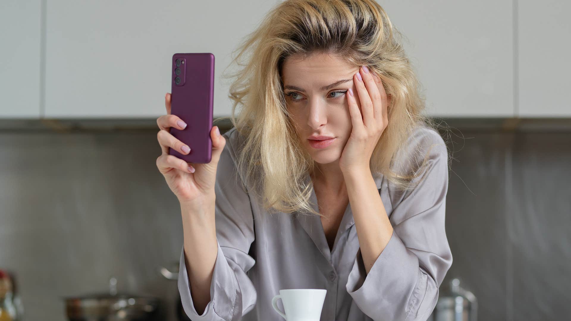 unhappy woman looking at phone annoyed by minor inconveniences