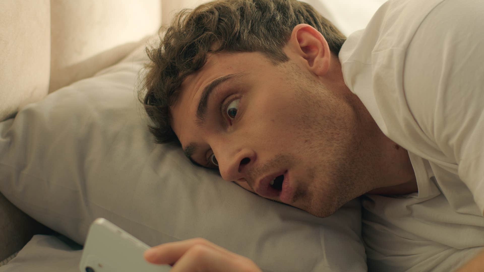 man looking at phone before rushing around