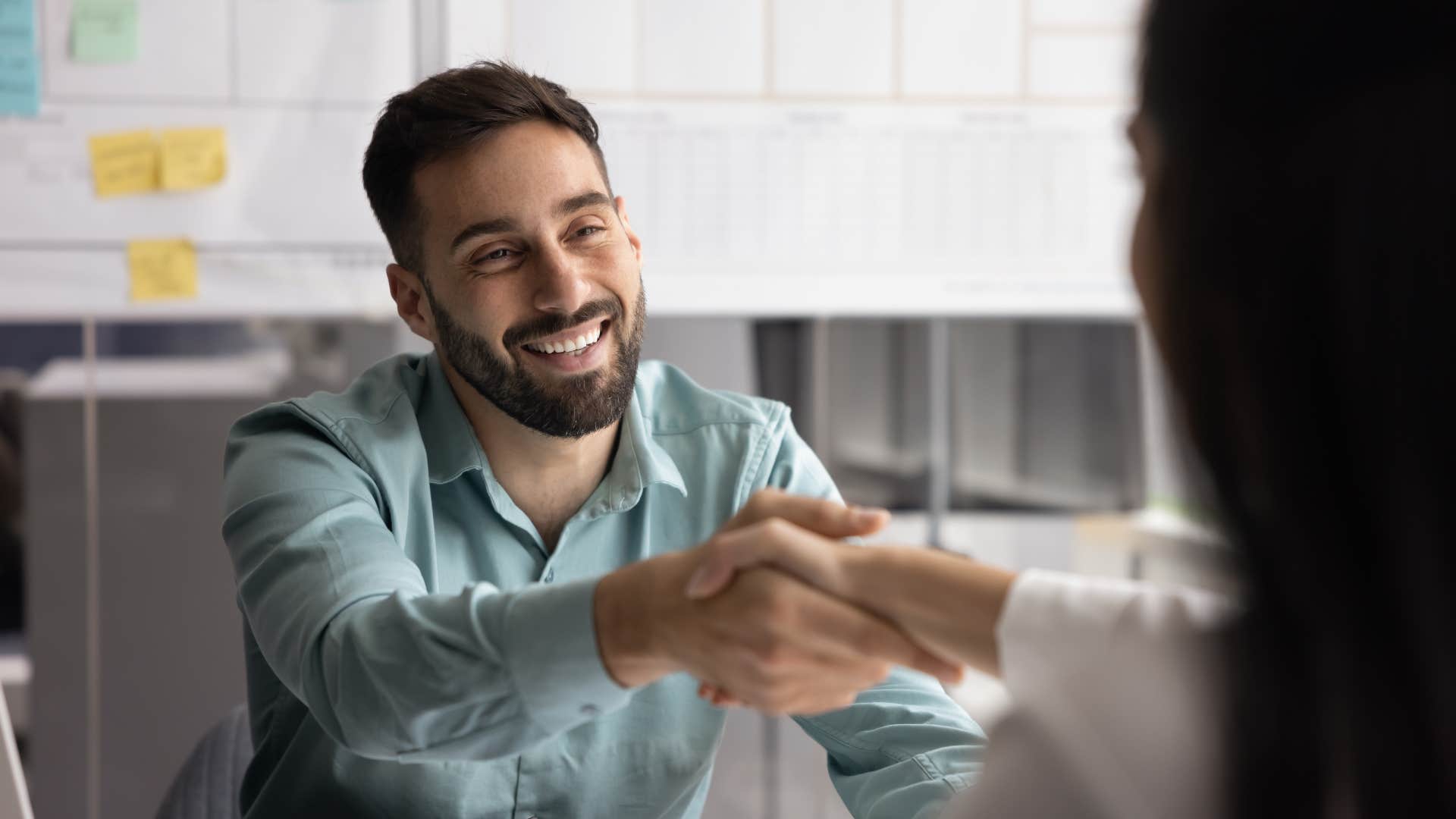man shaking hands as he always greets people when they enter a room