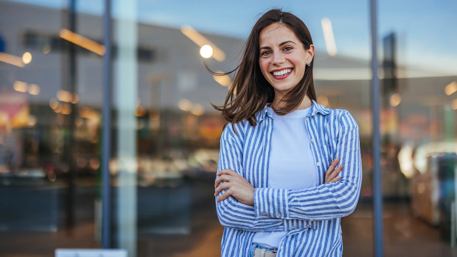 woman smiling brightly and crossing arms as she keeps her word no matter what