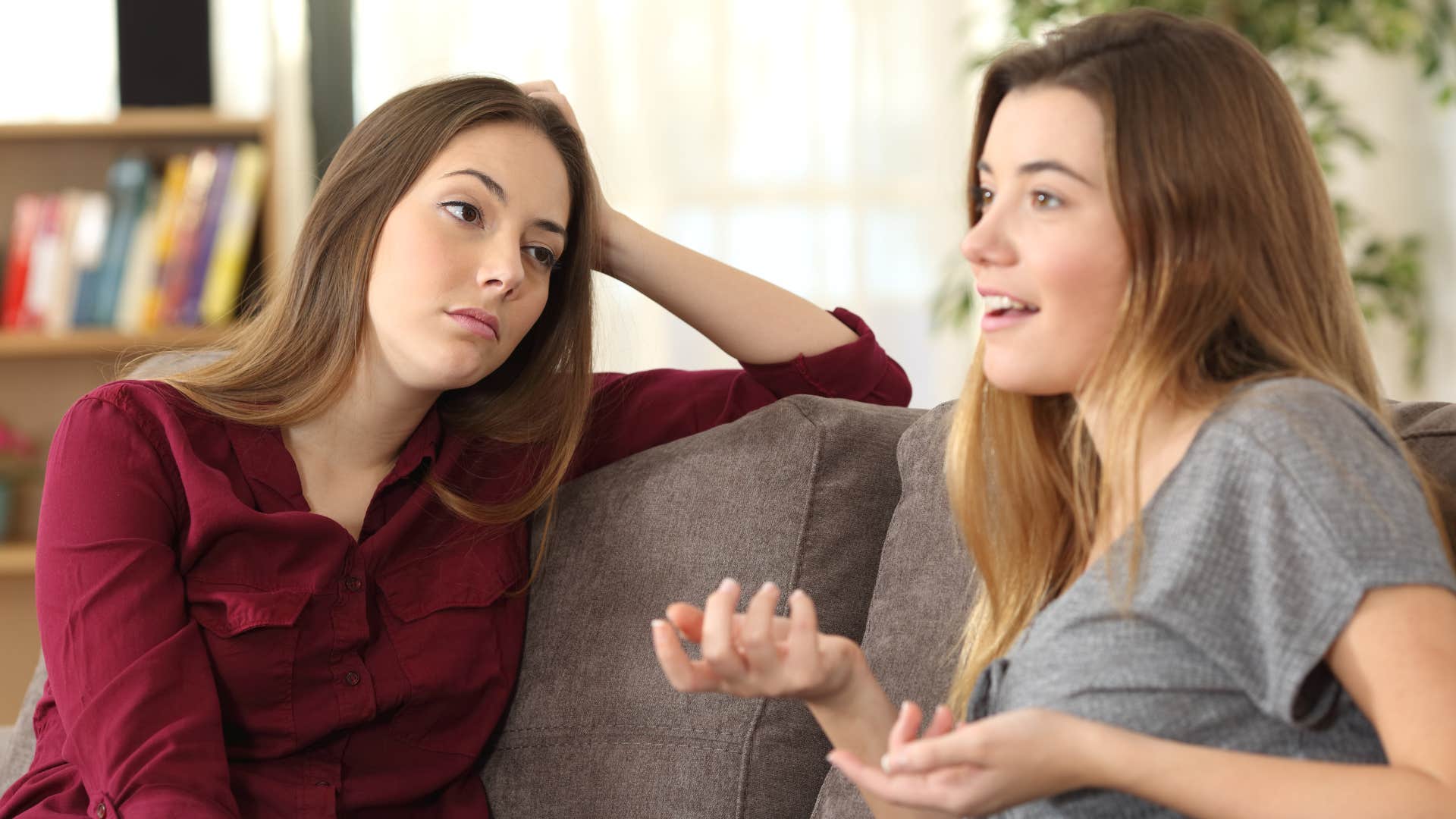woman in red annoyed as friend always interrupts someone mid sentence
