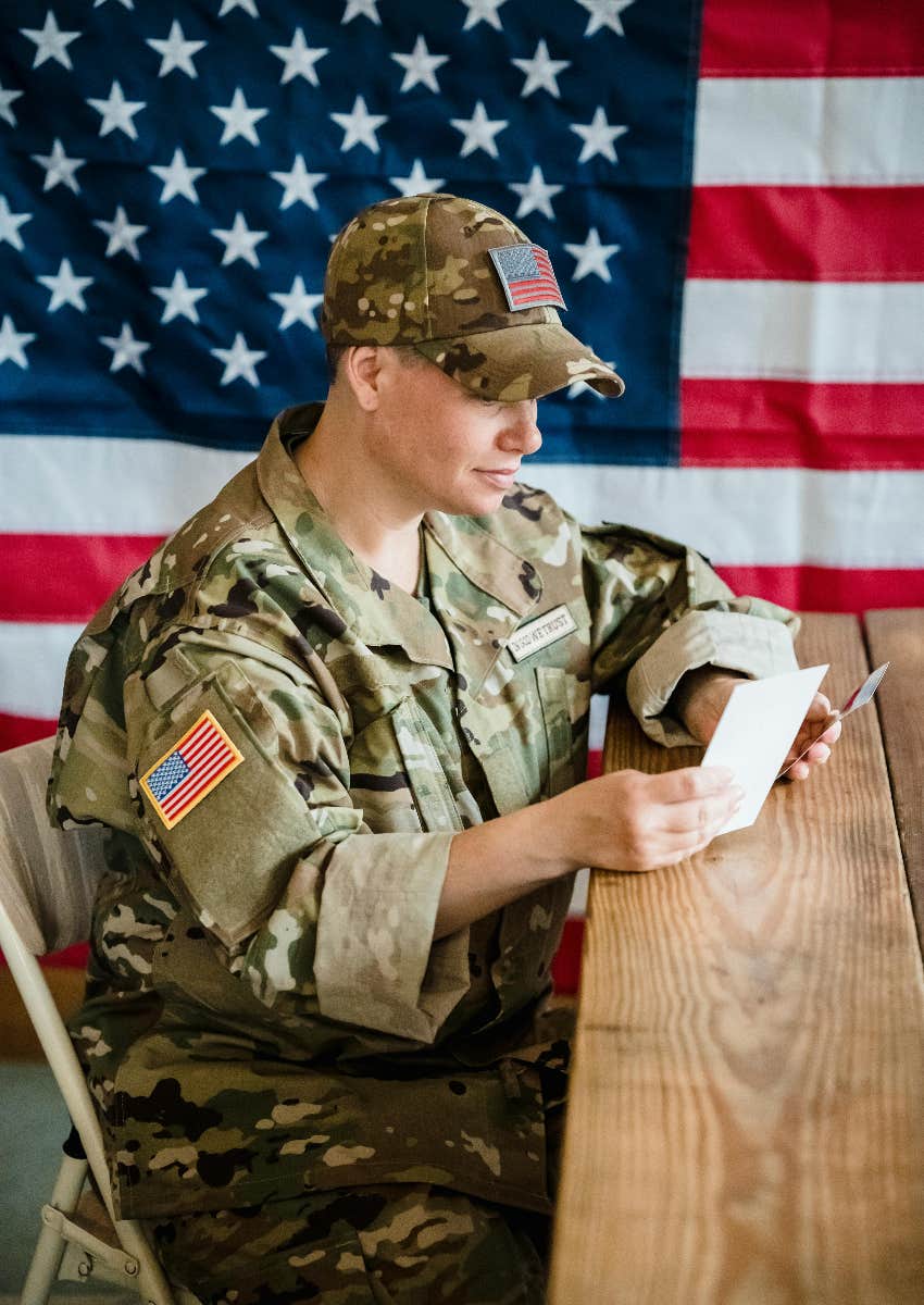 soldier reading a letter she received from a kid