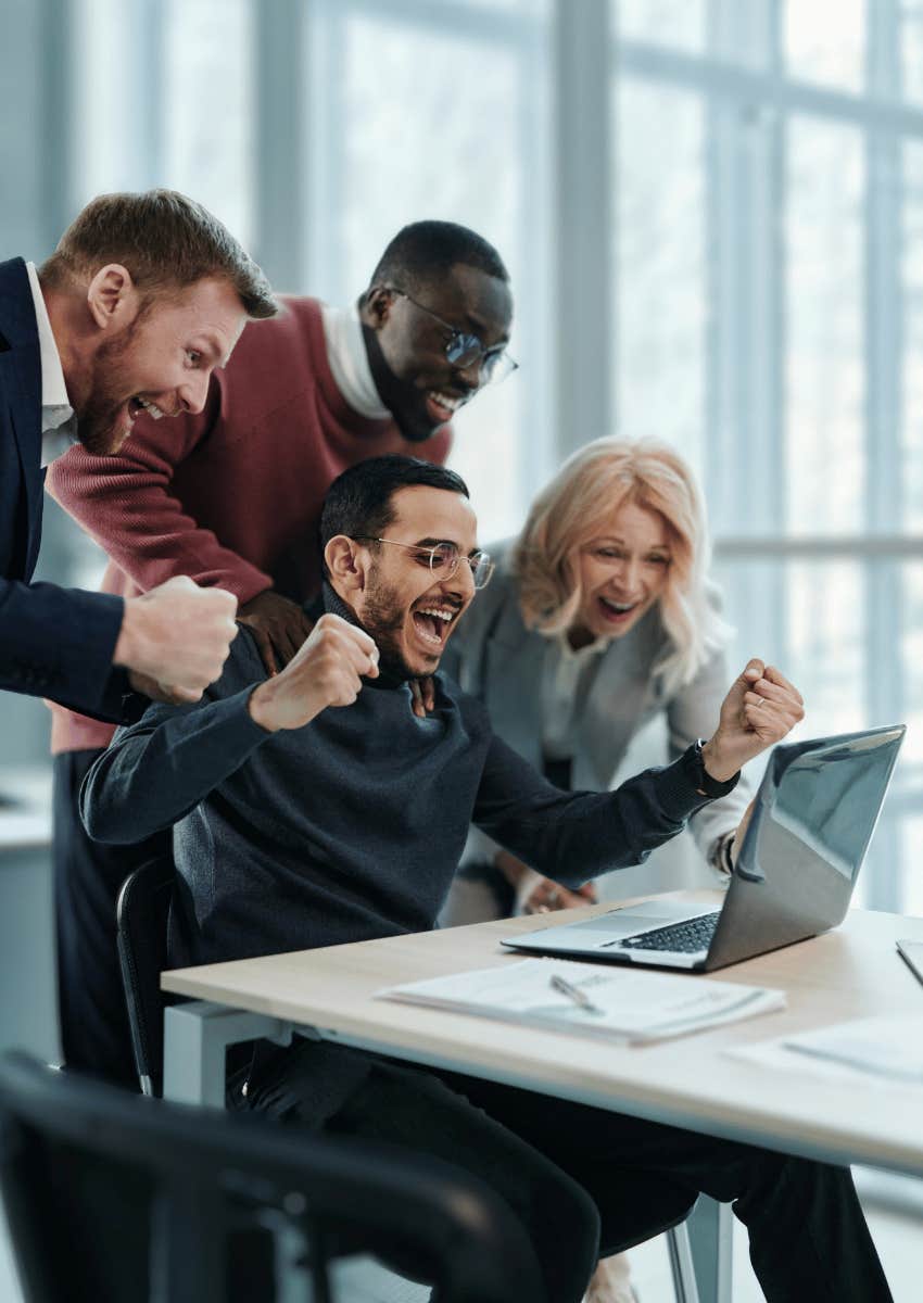 victorious group of coworkers cheering