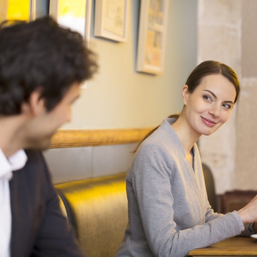 woman flirting with man without being obvious by smiling