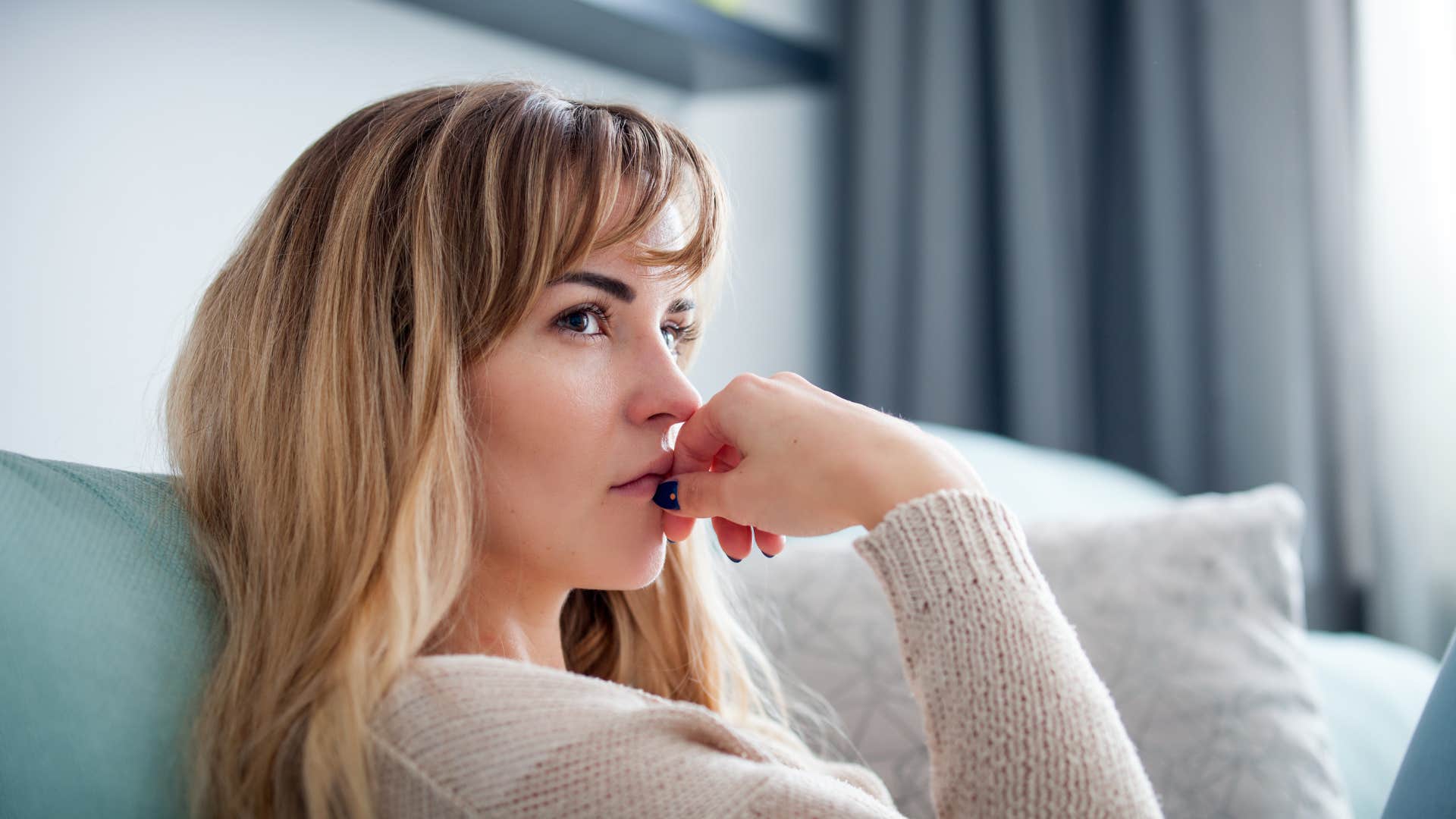 woman in white over focused on fairness at the expense of reality as she thinks deeply