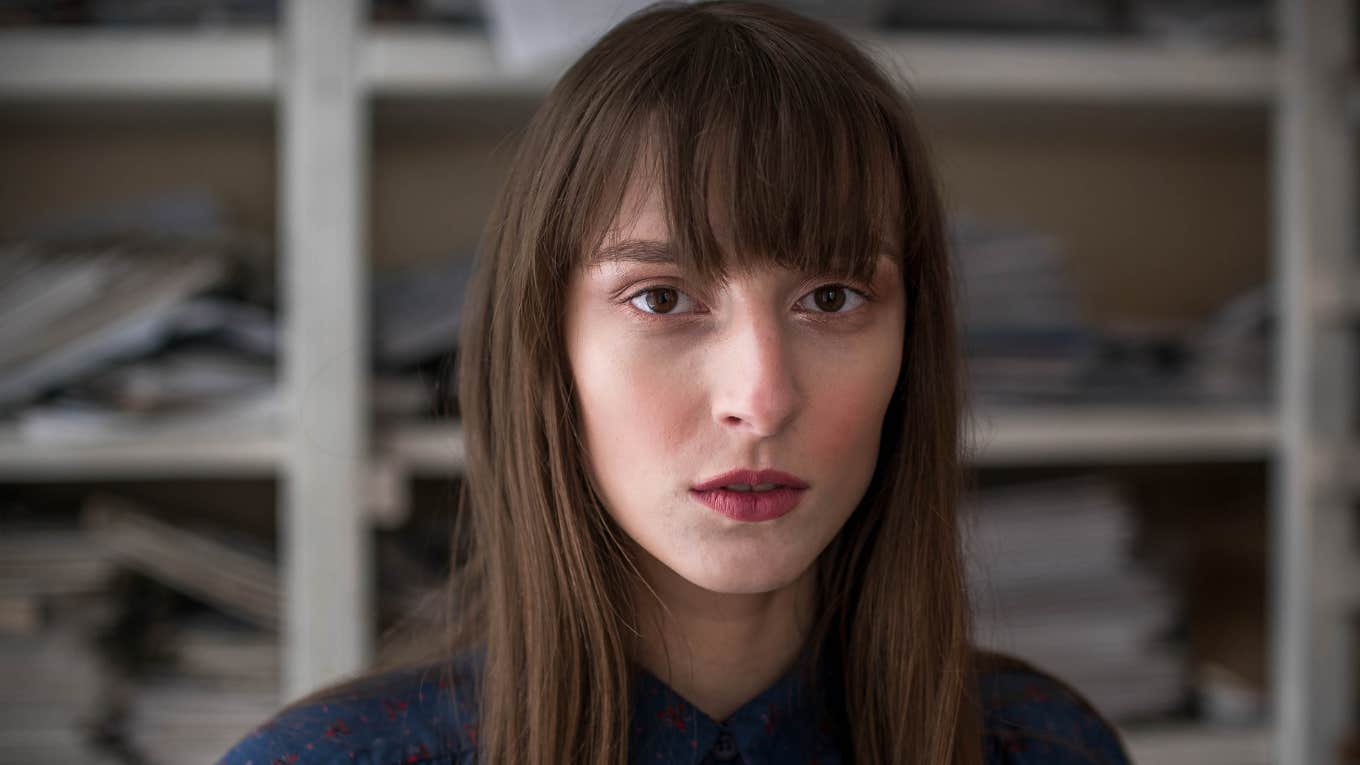 serious sullen woman lying about her life