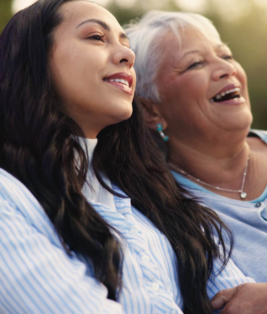 Elder mother sits with forgiving daughter showing healing from growing up