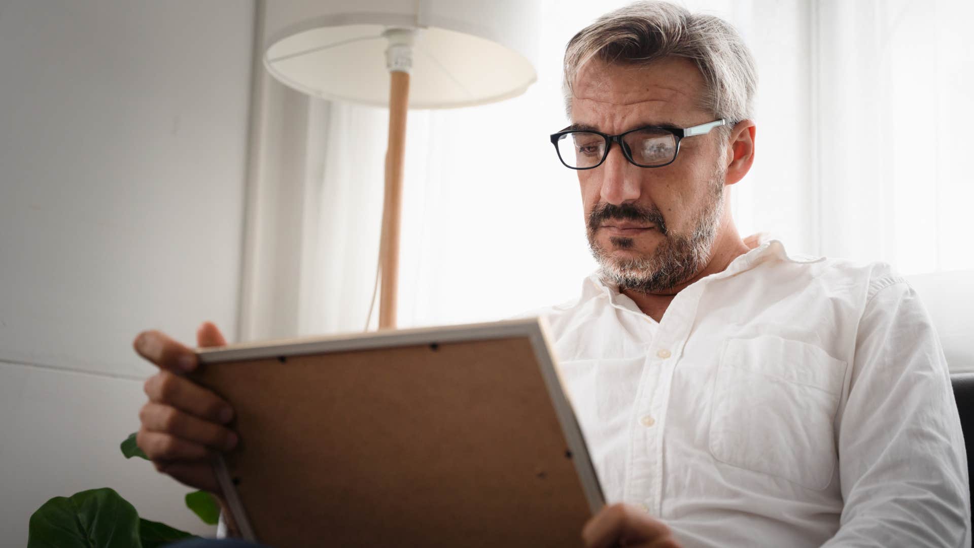 unmotivated man not asking for help sitting alone 
