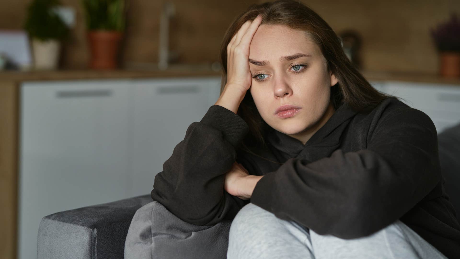 unmotived woman not keeping up with hobbies sitting at home