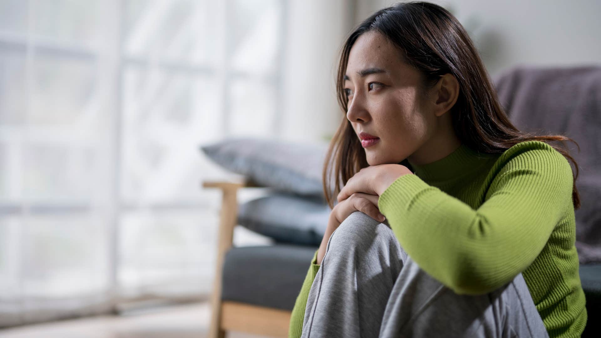 woman struggling to respond to texts at home