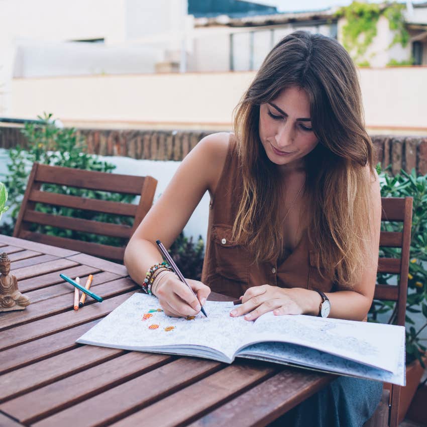 woman doing the simple thing of coloring that makes her happy