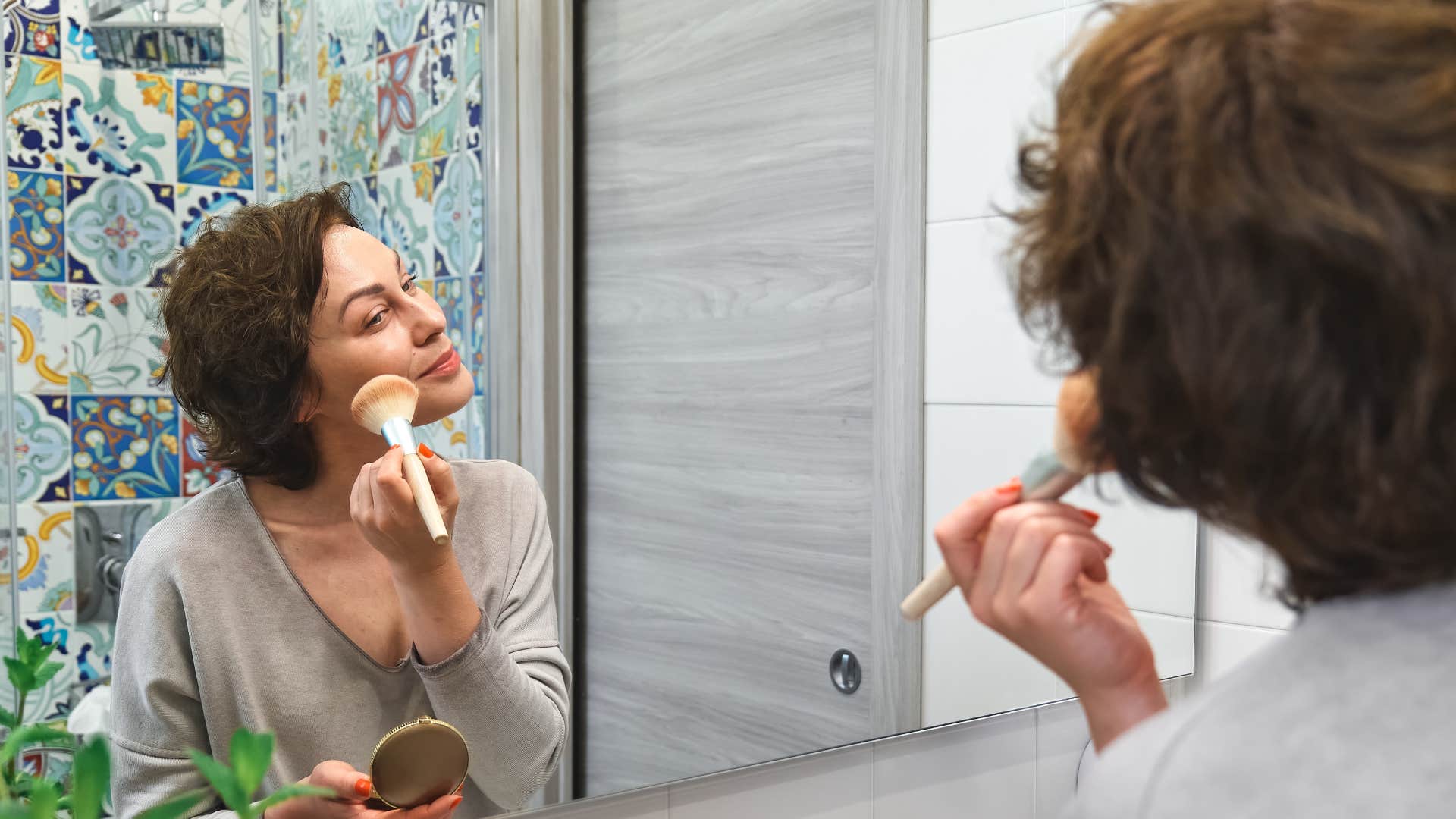 unhappy woman getting ready quickly putting on makeup