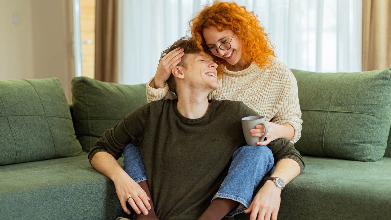 happy couple snuggling on the couch