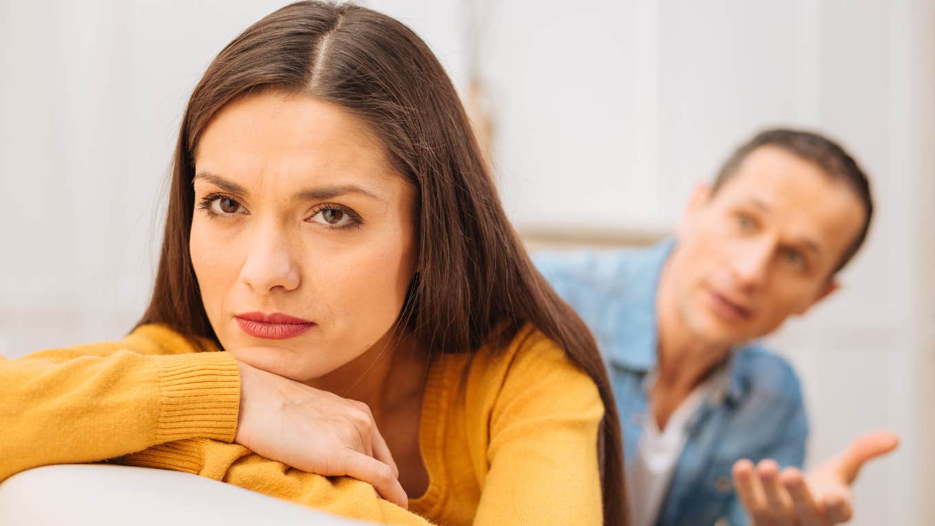 passive-aggressive woman ignoring husband trying to talk to her
