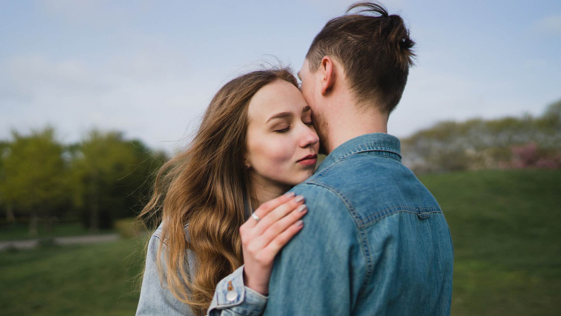 woman hugging husband trying to protect his feelings