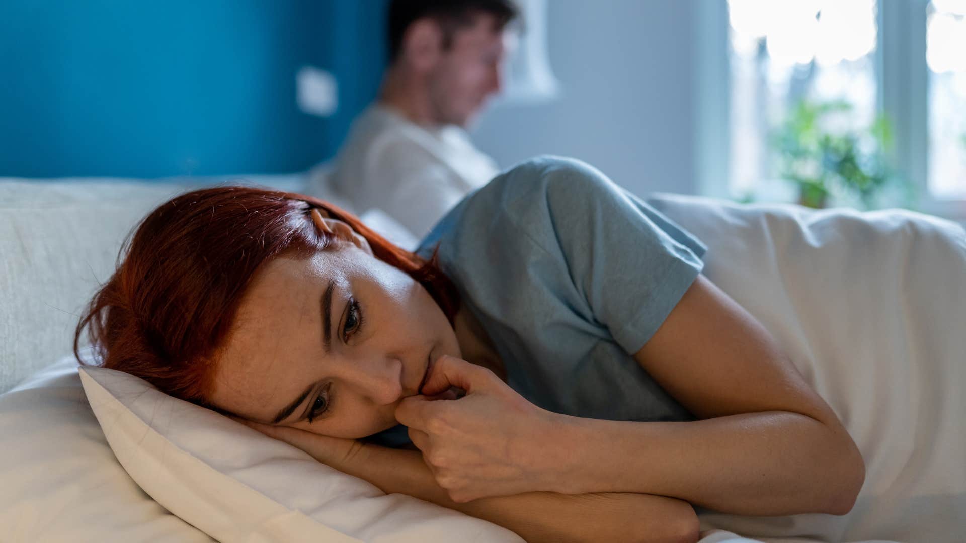 woman in bed next to partner feeling unheard