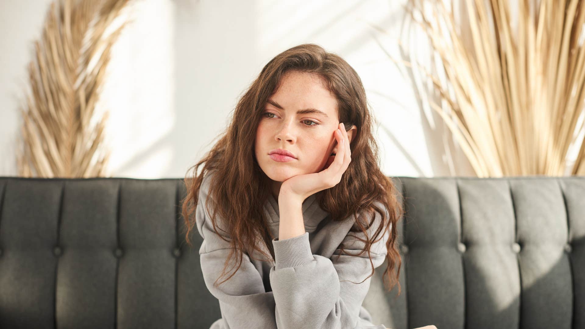 woman afraid to be vulnerable sitting alone