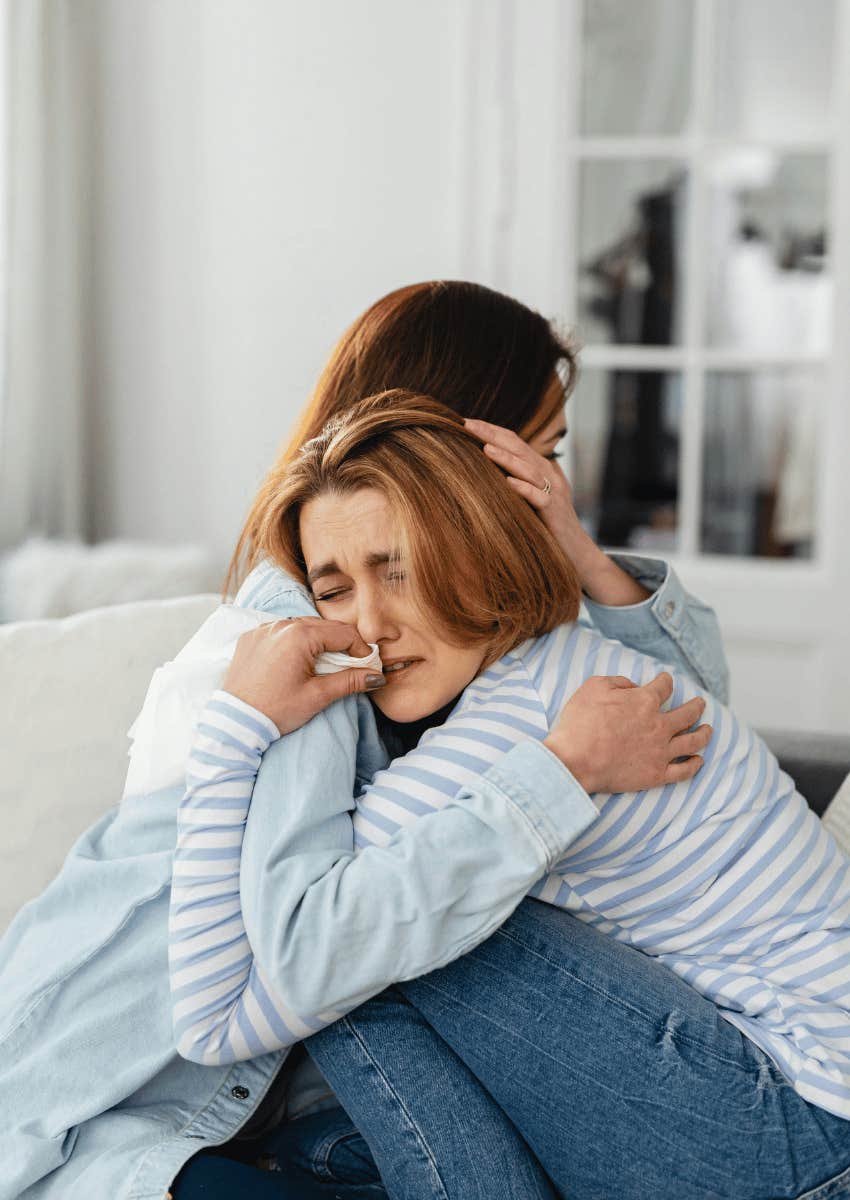 woman leaning on her friends after a breakup