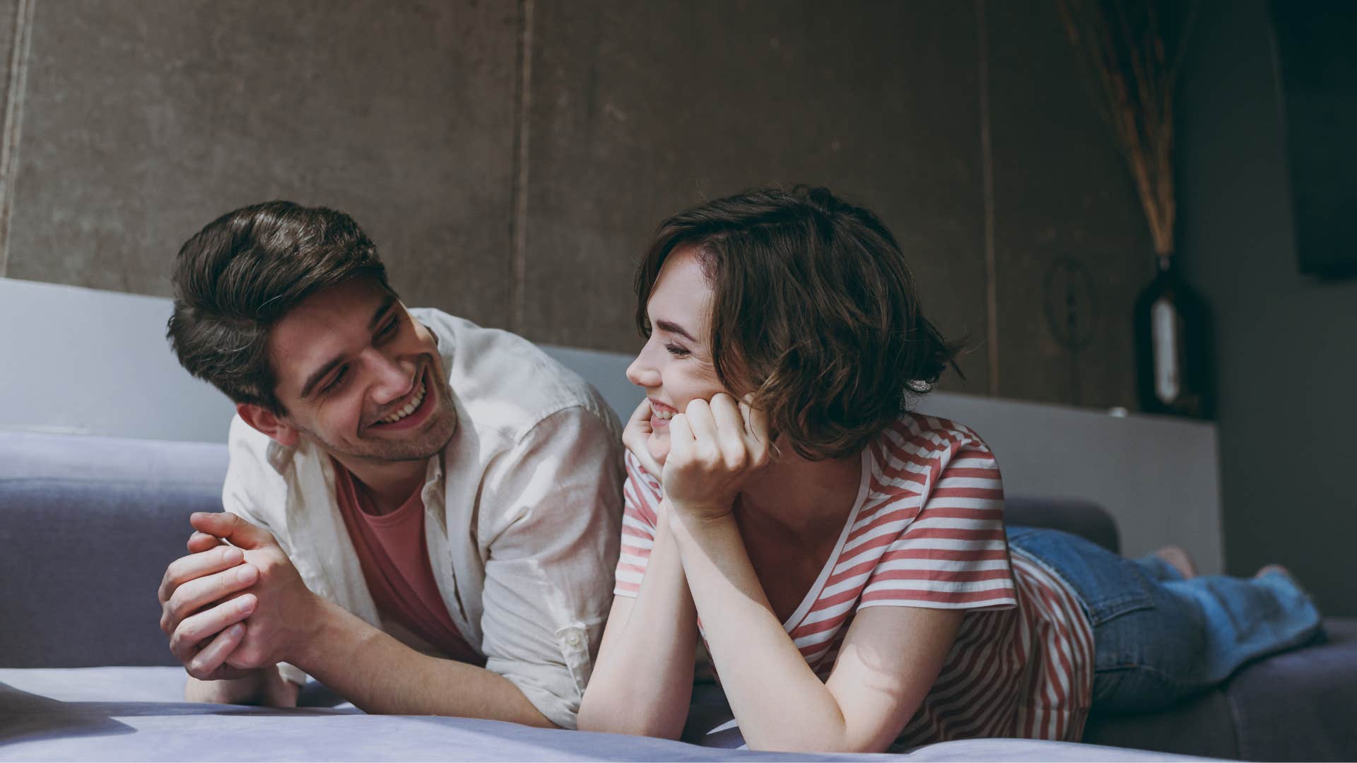 smiling happy couple complimenting each other on the floor