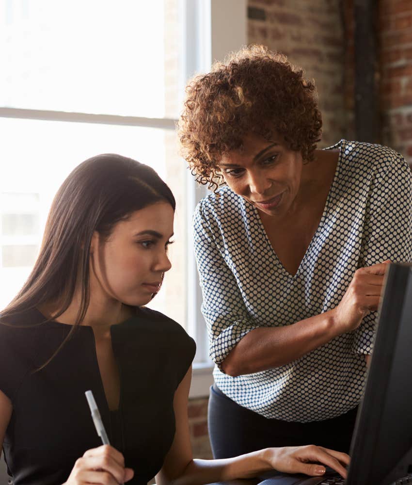 Attentive woman learns from mentor showing simple rule to build career