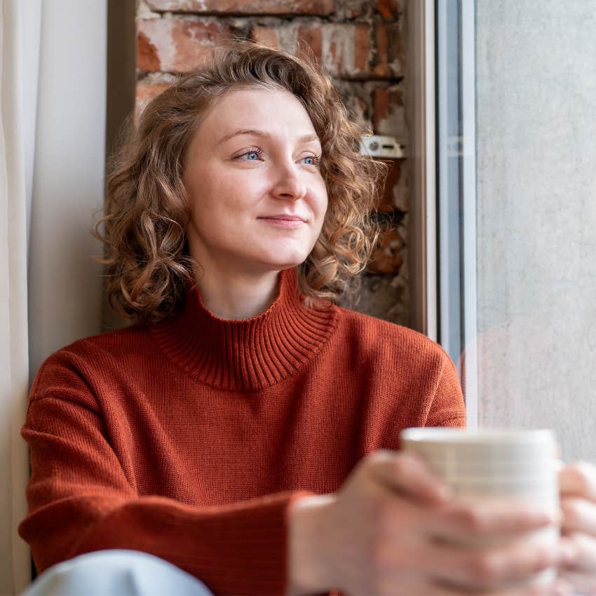 woman appreciating slow, intentional mornings with a cup of coffee