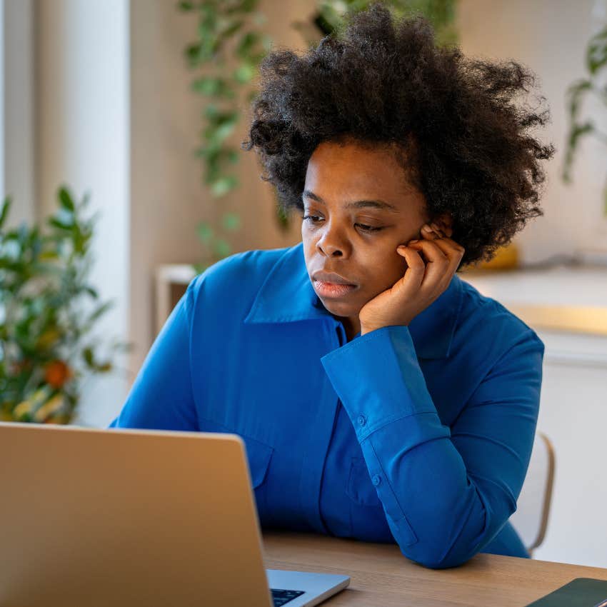 unhappy woman working while dealing with stress and fatigue