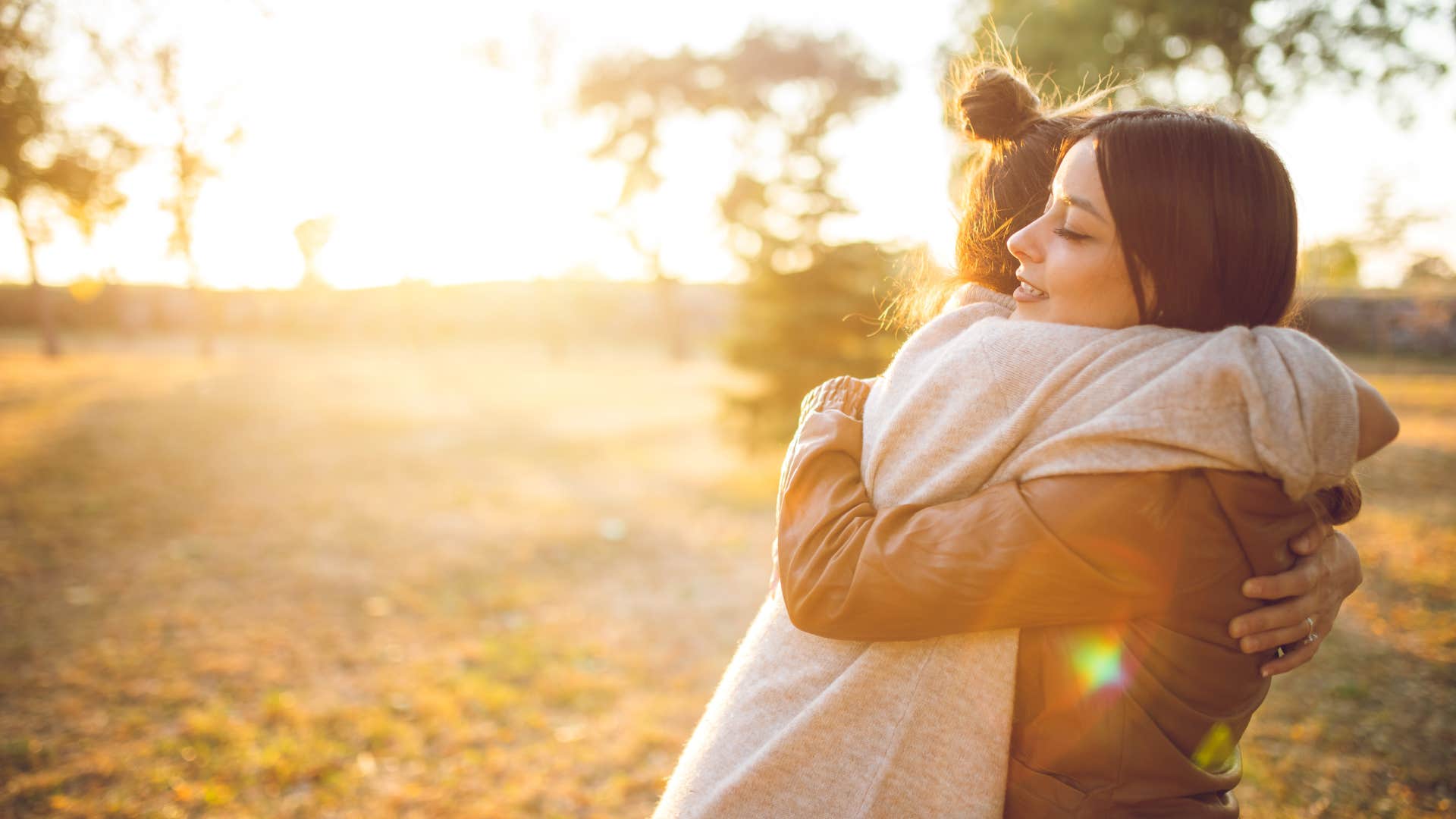 woman hugging friend kindly