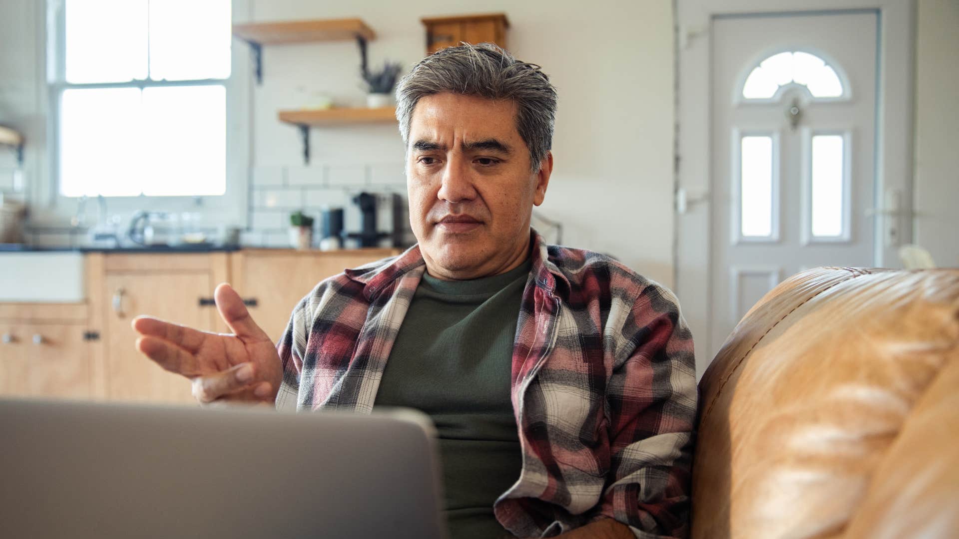 middle-aged self-reliant man using laptop at home