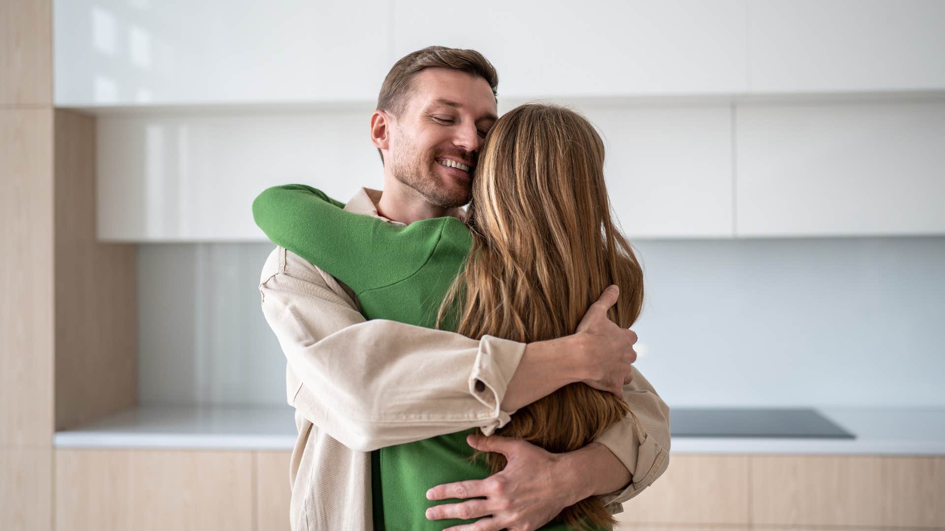 man hugging his committed wife