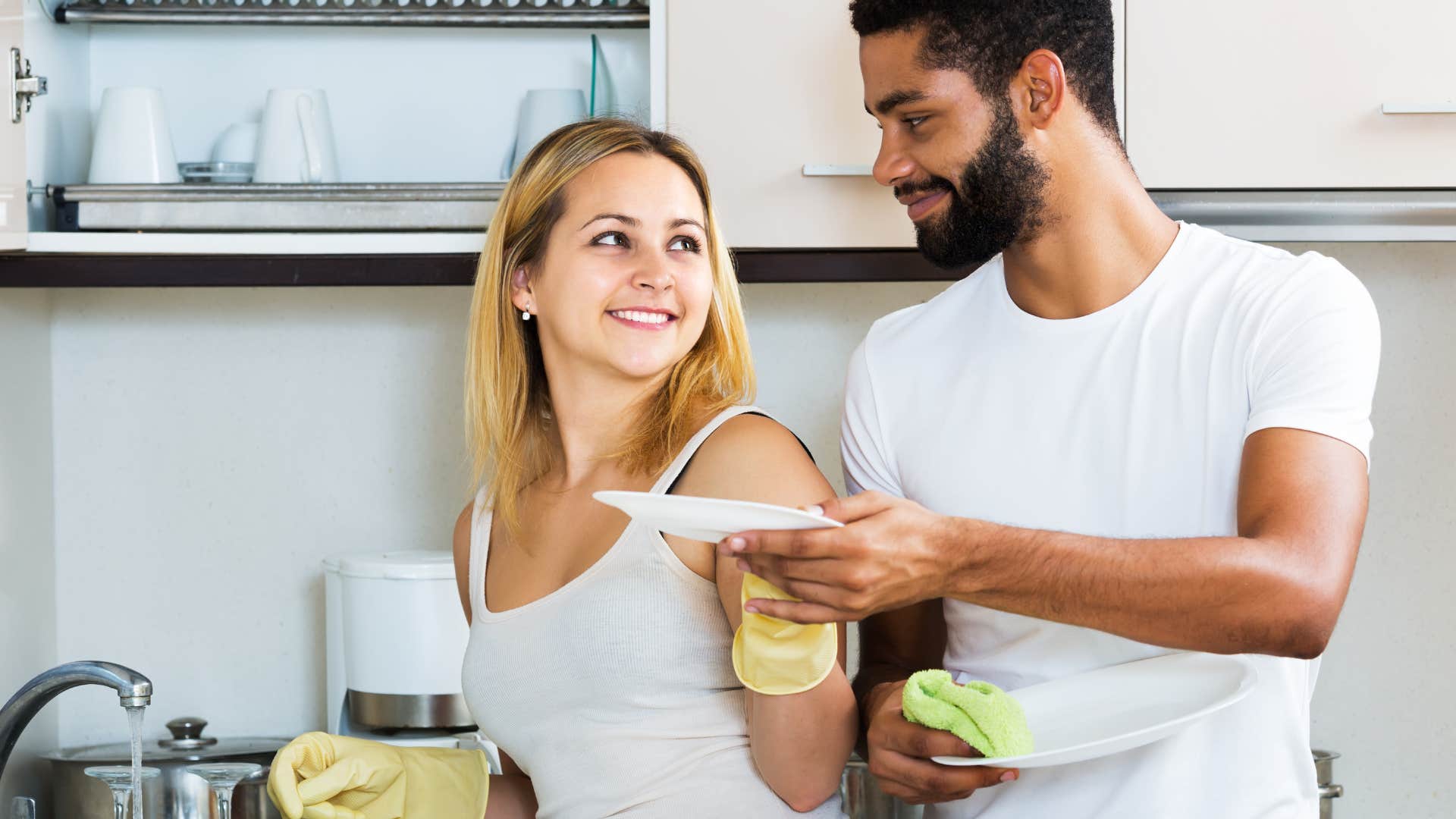man helping hardworking wife do dishes
