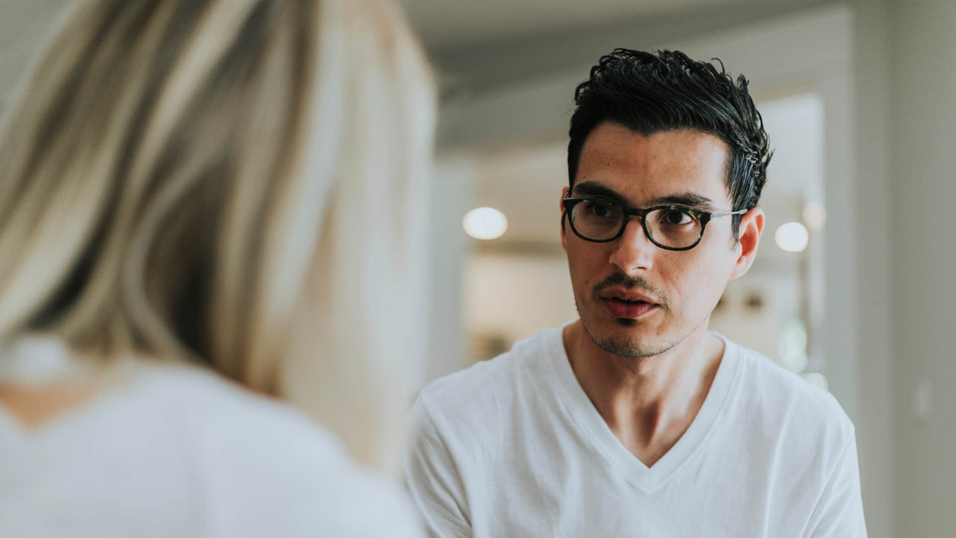 man with a dark agenda telling woman shes the problem