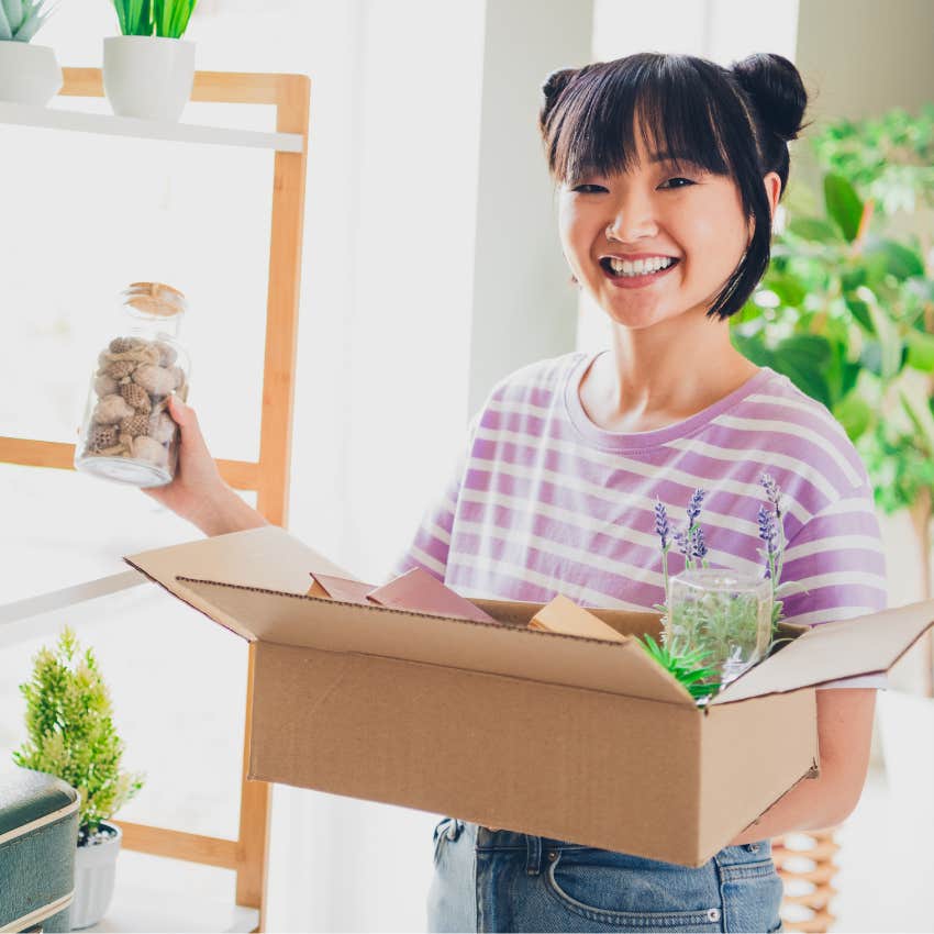 woman who keeps everything just in case holding a box of items