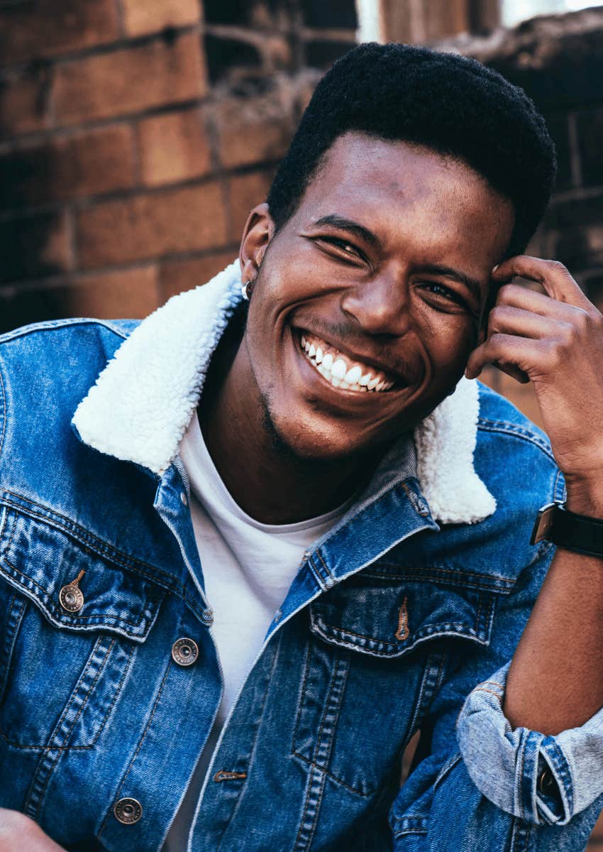 young man smiling grateful for everything else after breakup