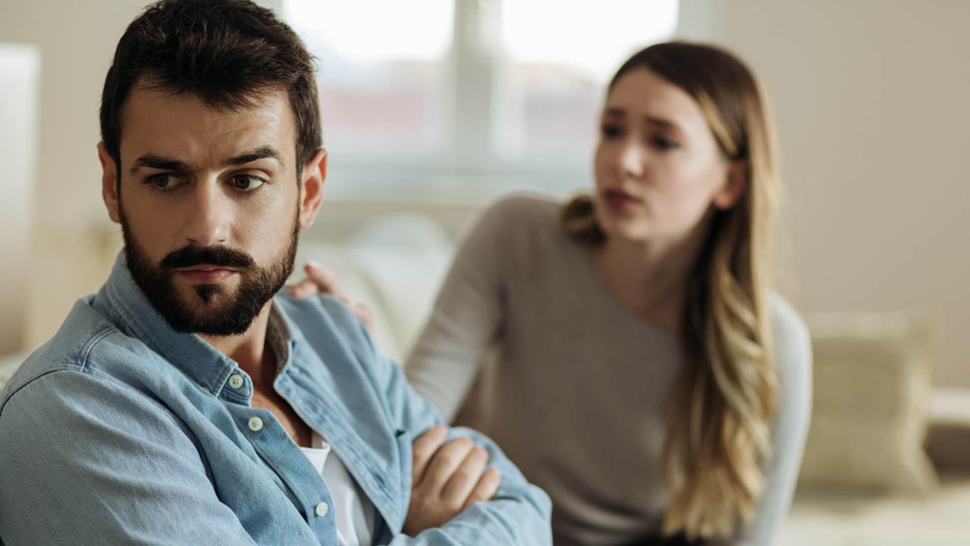 man turned away from upset wife ignoring her security