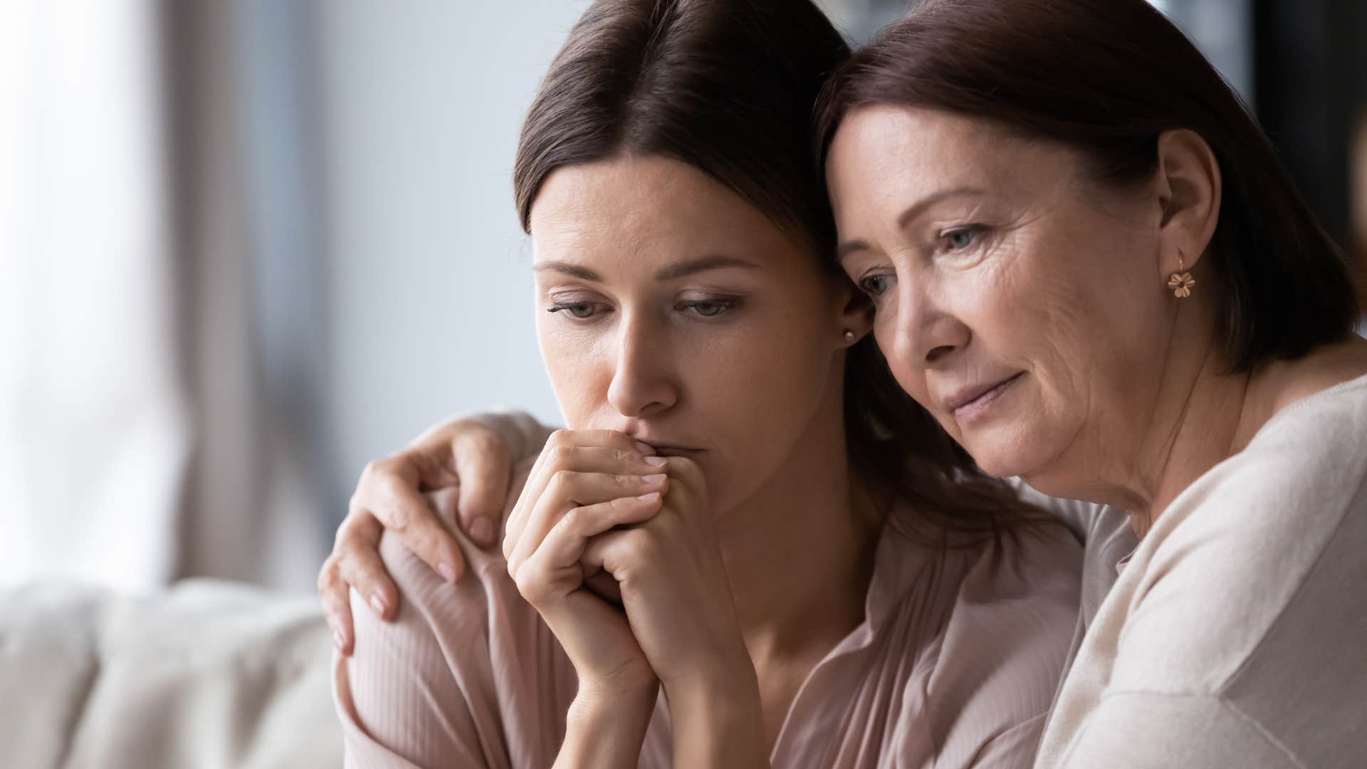 older mother hugging adult daughter to make sure she's okay