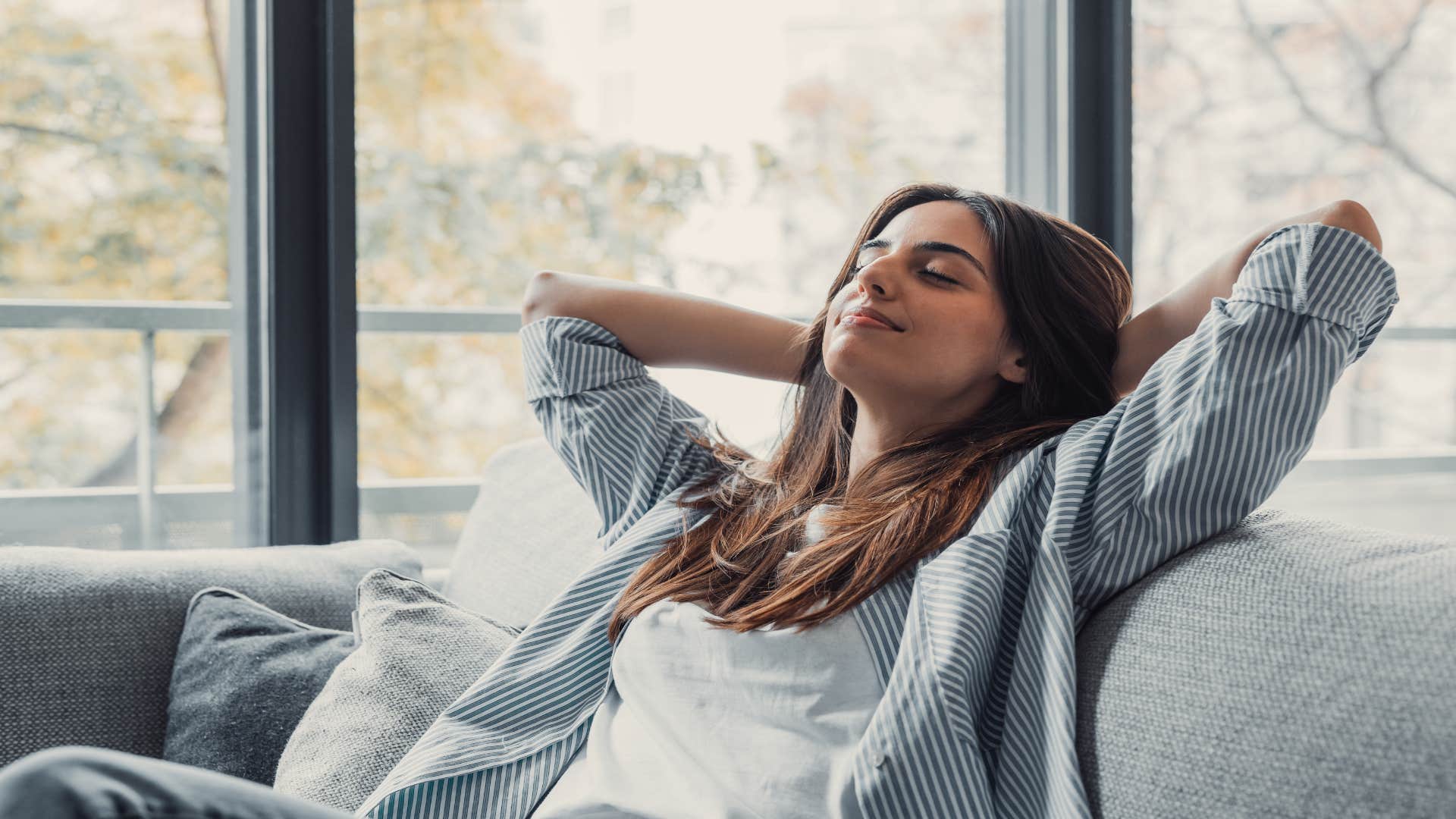 Relaxed woman on the couch with a smile on her face