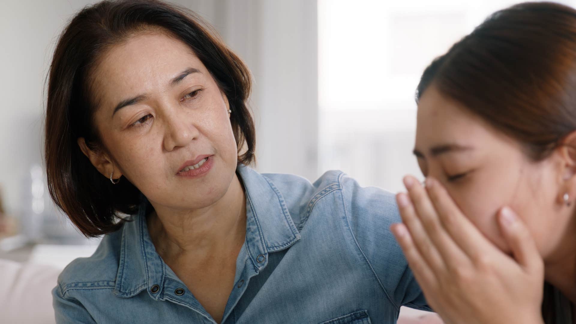 mother comforting daughter who keeps bringing up old conflicts