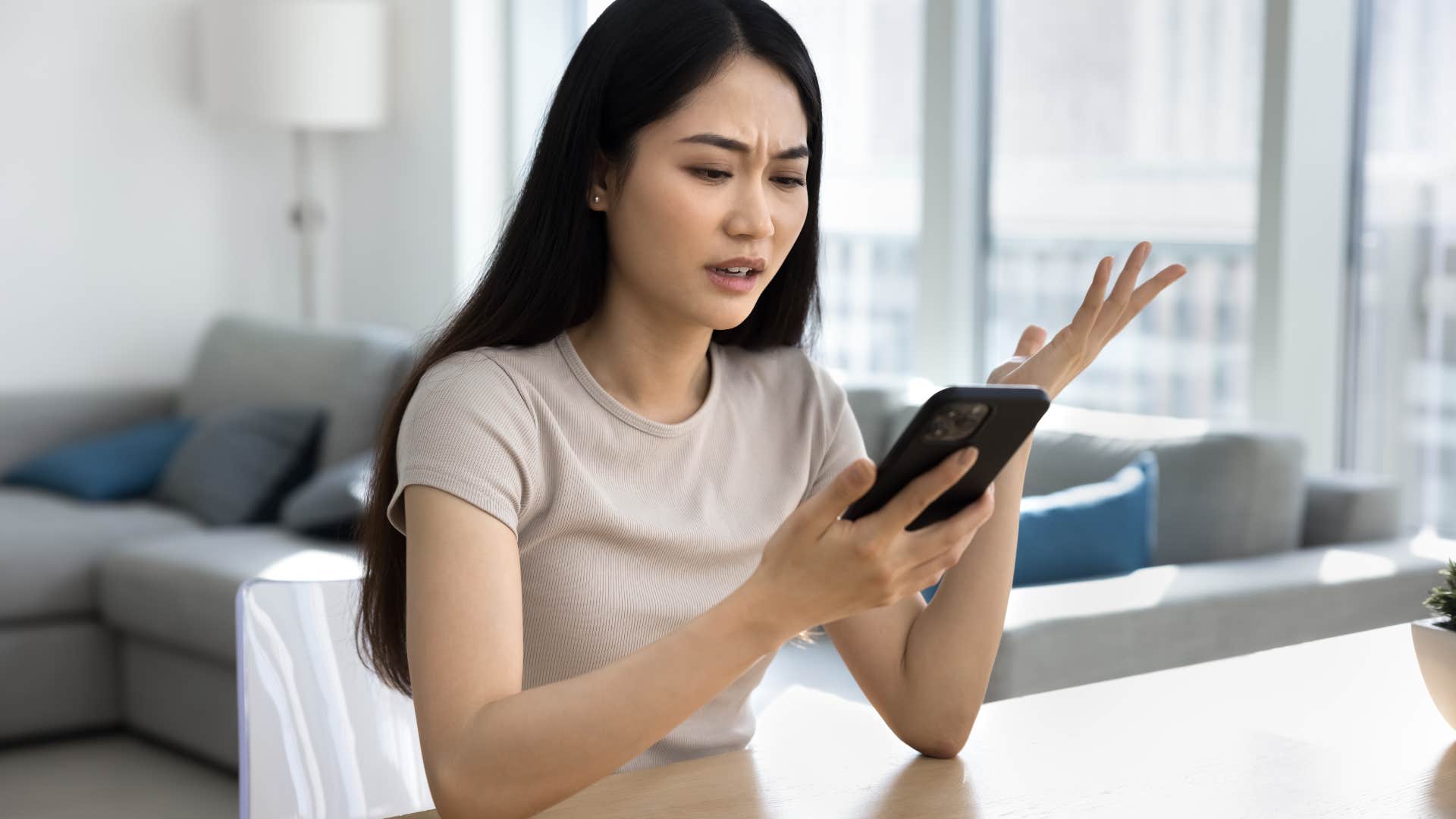 annoyed woman looking at her phone