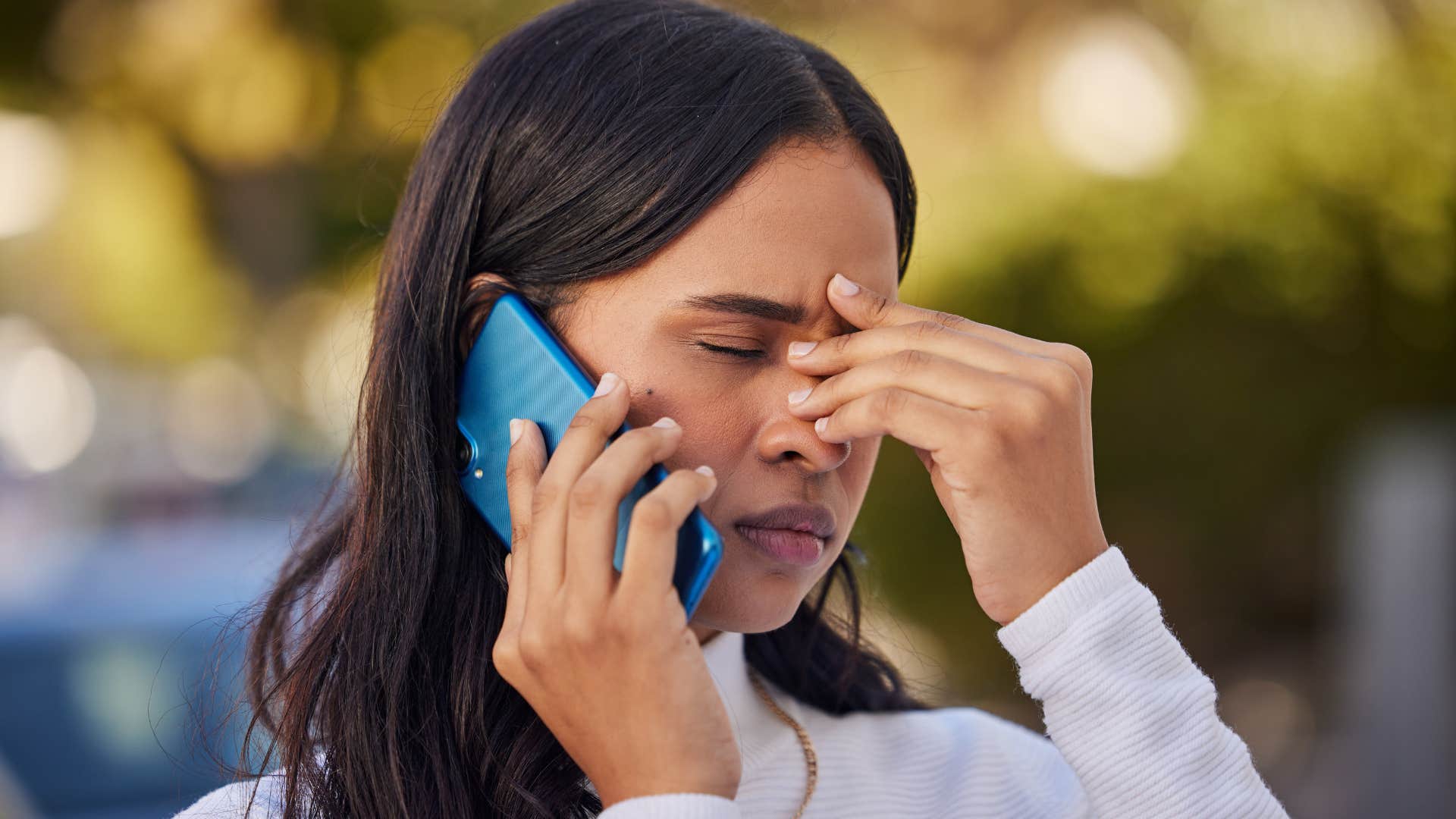 frustrated woman talking on phone with her parents