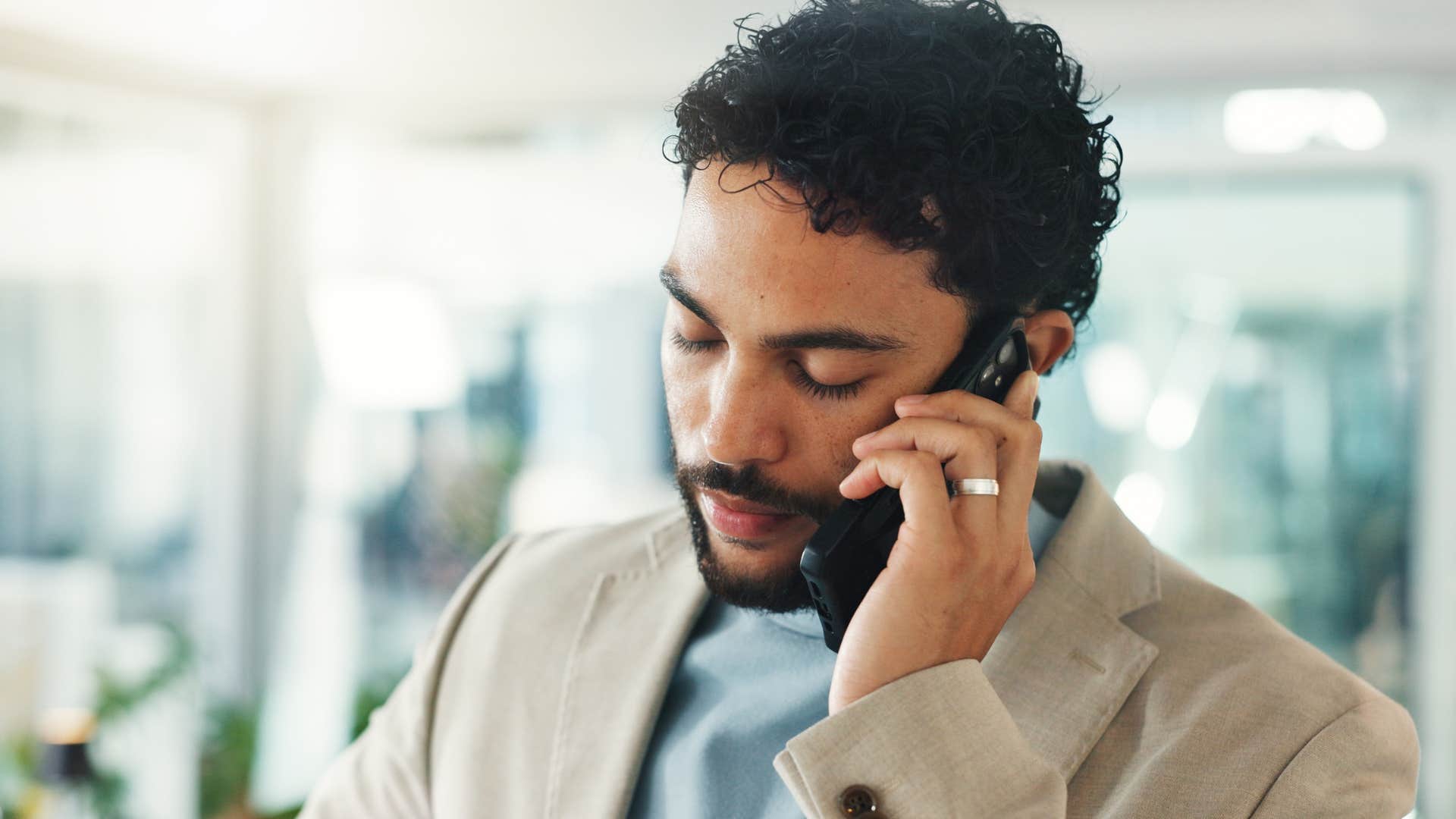 frustrated man talking on phone with disrespectful parents