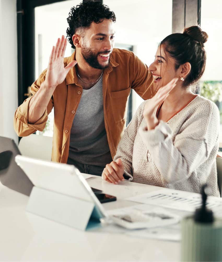 Happy partners high five showing habitual goal of imagineers