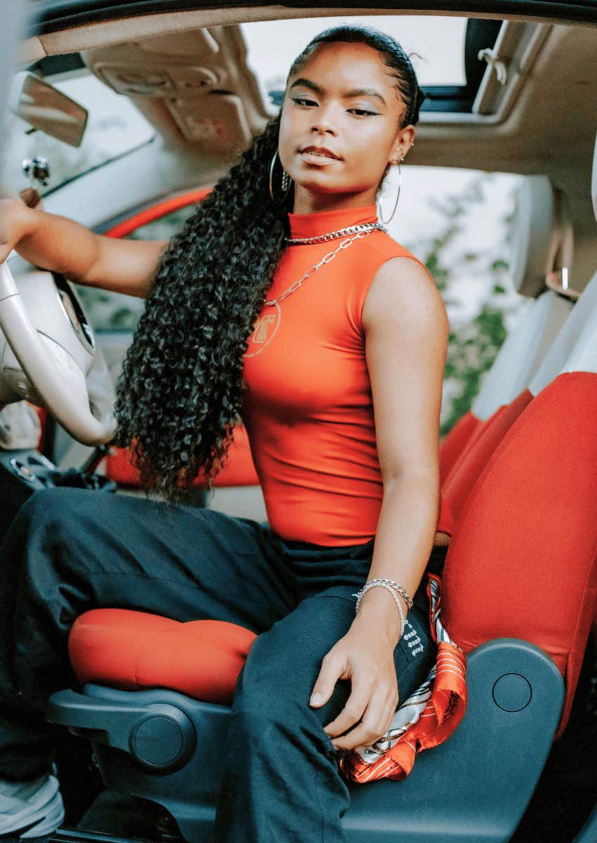 attractive young woman sitting in a luxury sports car