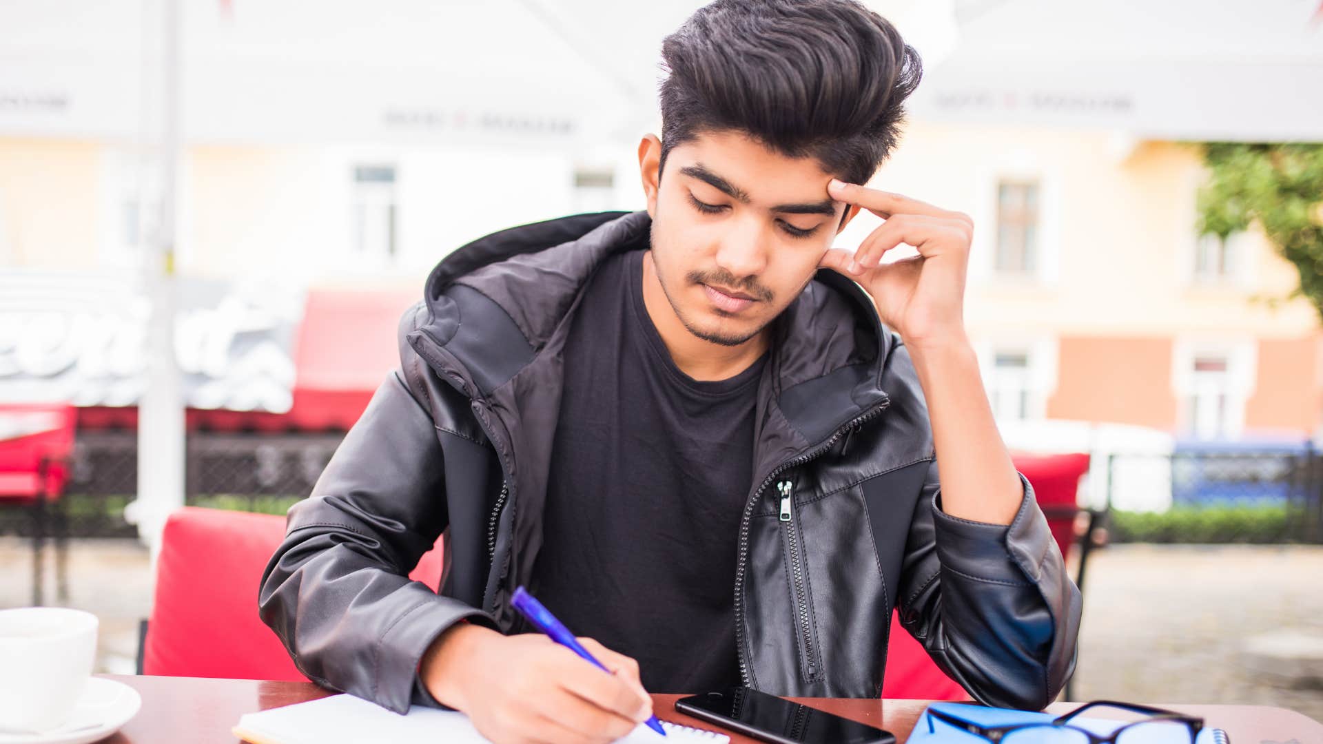 Gen Z man writing a love letter like a baby boomer 