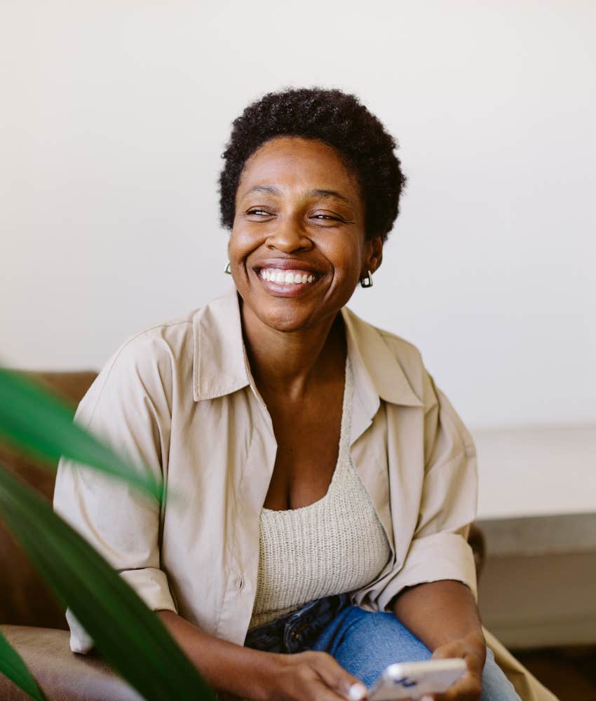 Happy person uses mobile tech showing millenial skill