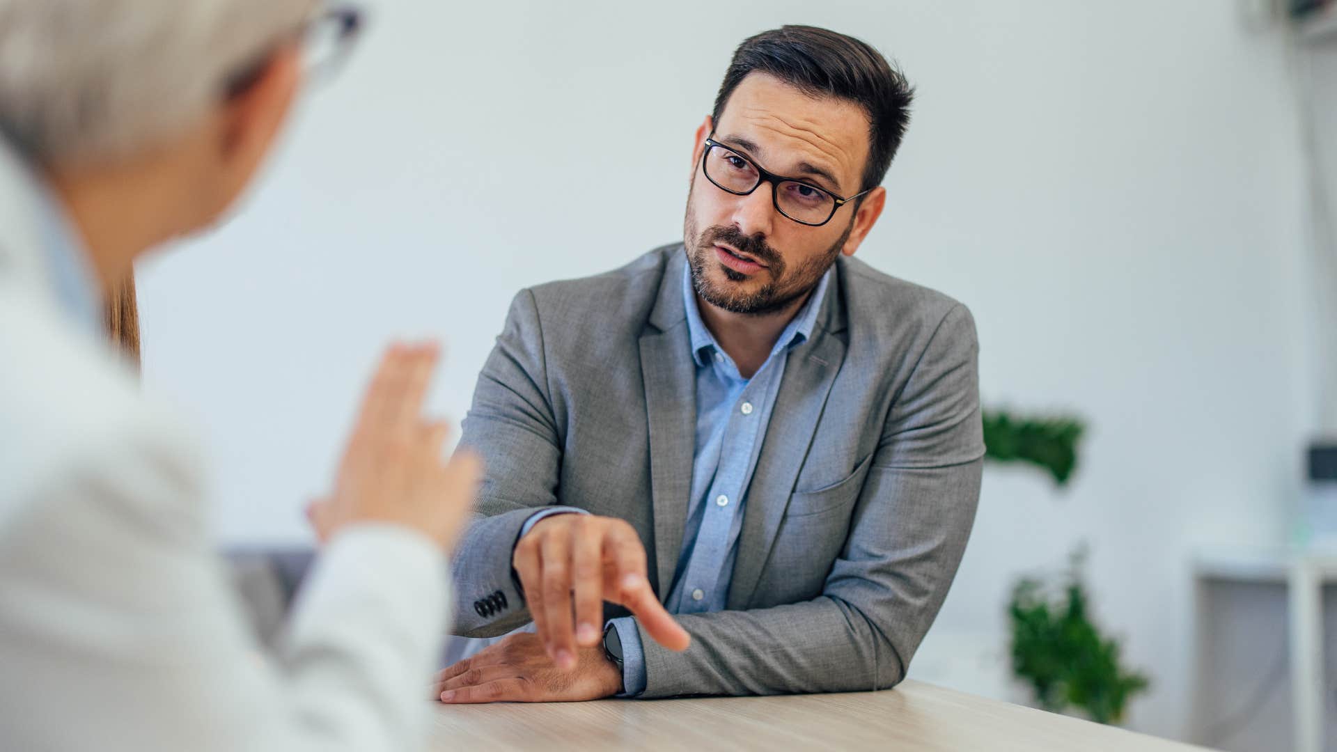Man who upholds and maintains boundaries speaking at work.