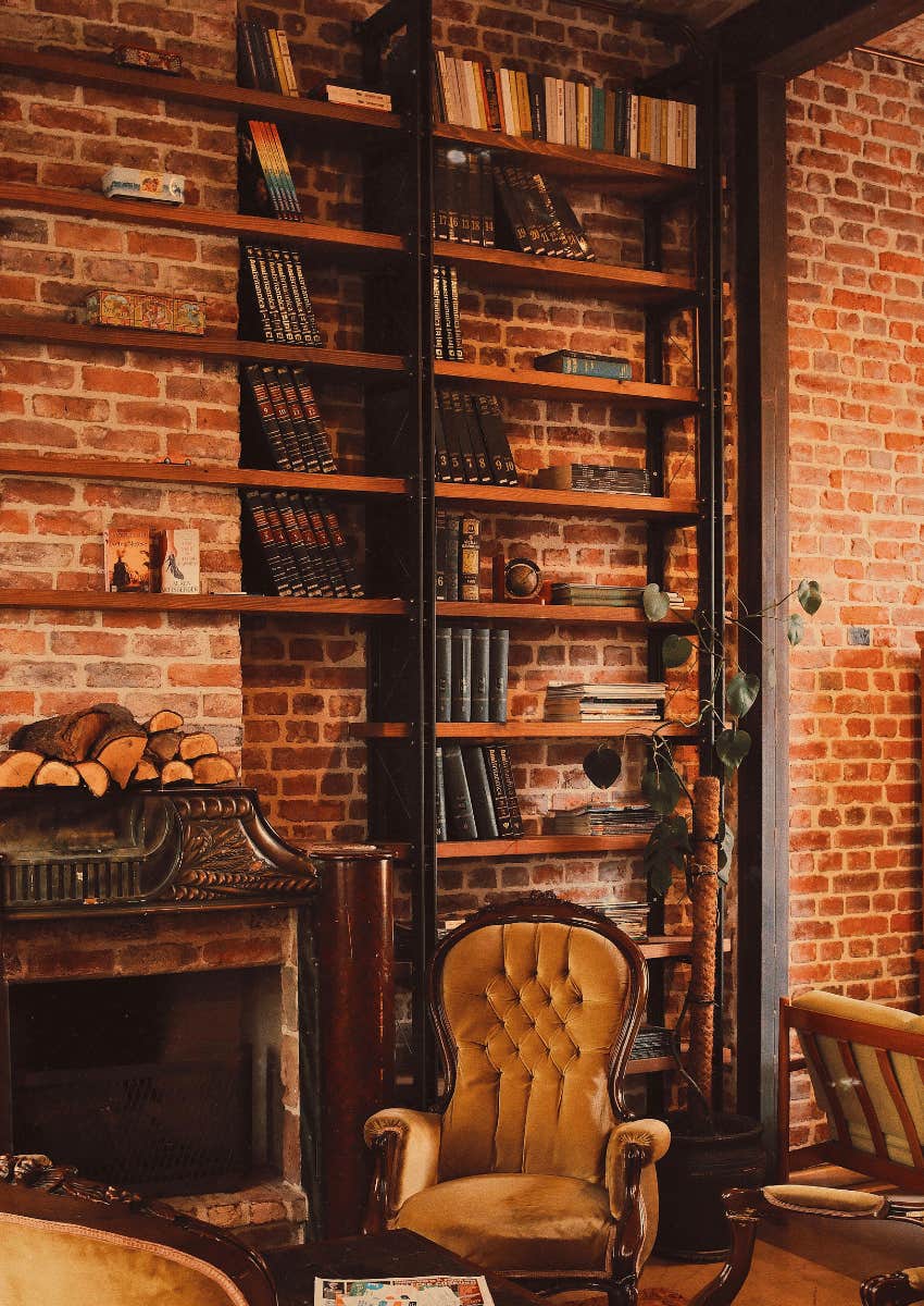 books stacked near a fireplace