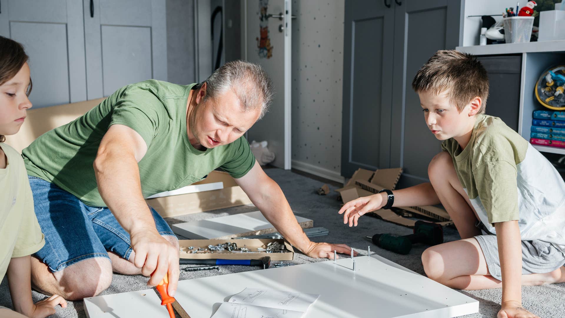 Boomer dad doing projects with kids 